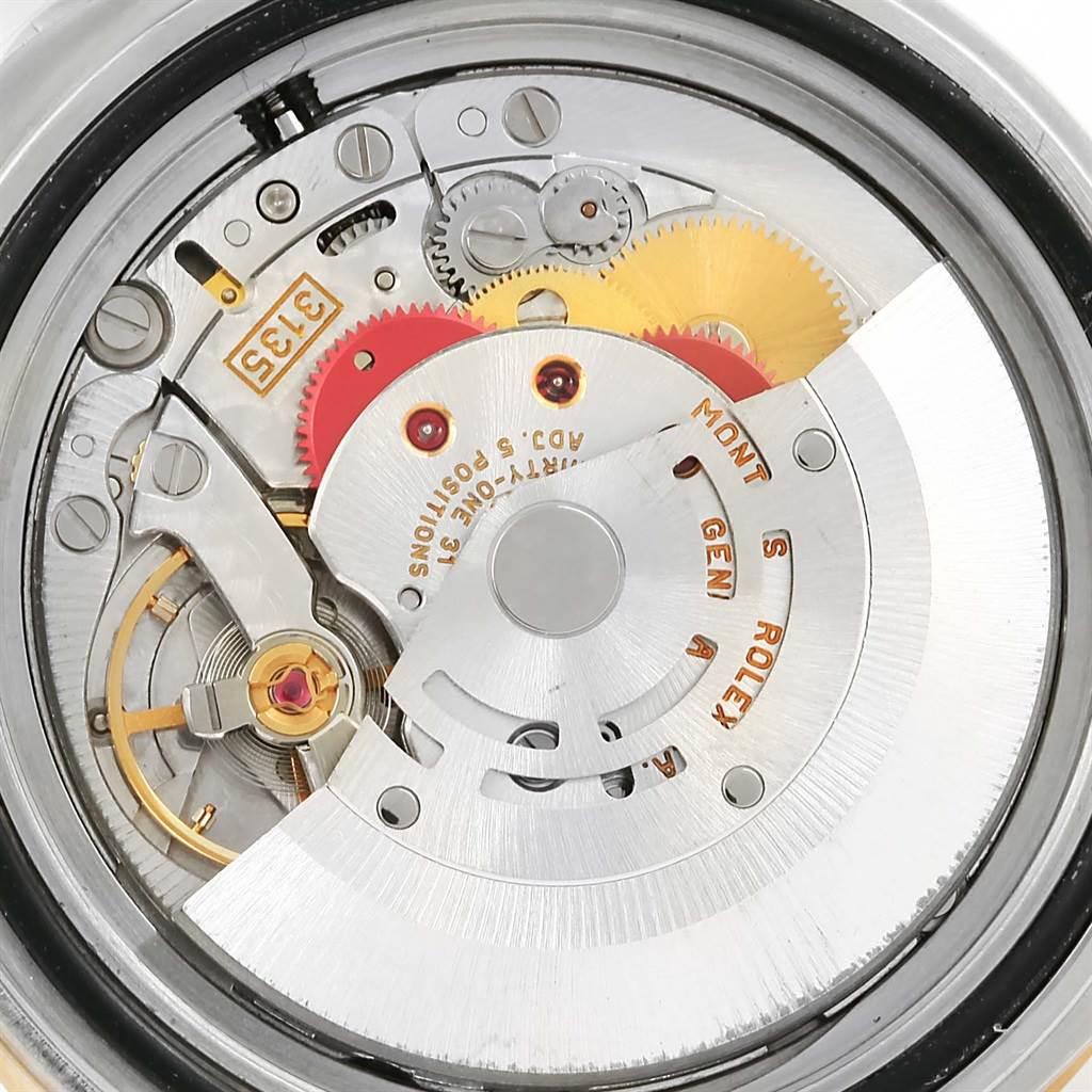 The image shows the internal movement mechanism of the Rolex Submariner 16613 Men
s Steel and Gold (two tone) Grey Dial 16613 Men
s Steel and Gold (two tone) Grey Dial watch from a close-up back angle.