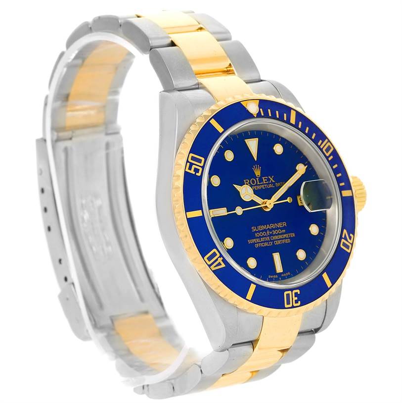 The image shows a Rolex Submariner 16613 Men
s Steel and Gold (two tone) Blue Dial 16613 Men
s Steel and Gold (two tone) Blue Dial watch at an angle highlighting its blue dial, bezel, two-tone bracelet, and case.