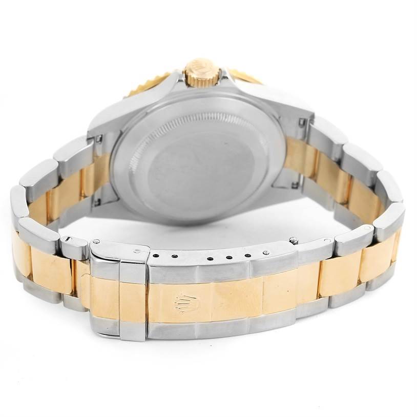 This image shows the back view of a Rolex Submariner 16613 Men
s Steel and Gold (two tone) Blue Dial 16613 Men
s Steel and Gold (two tone) Blue Dial, highlighting its two-tone bracelet and clasp.