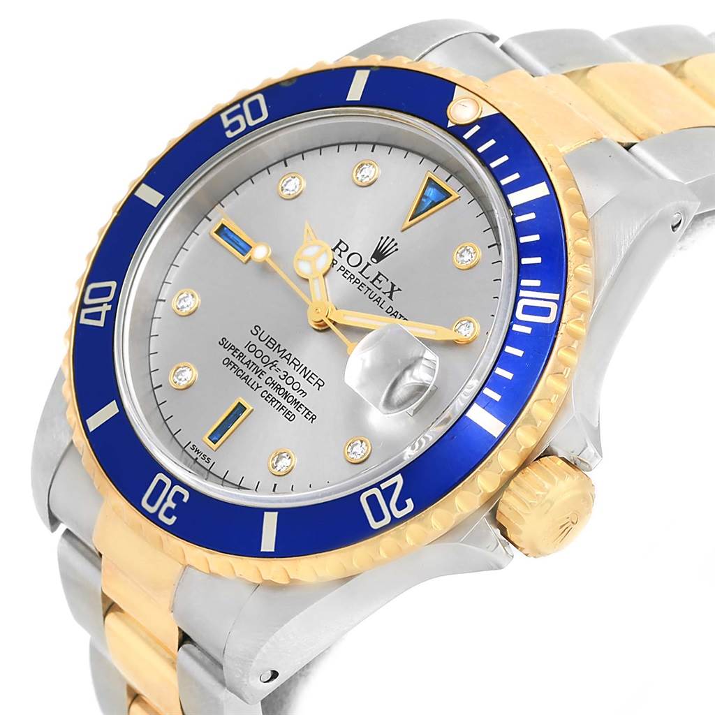 The image shows a Rolex Submariner 16613 Men
s Steel and Gold (two tone) Grey Dial 16613 Men
s Steel and Gold (two tone) Grey Dial watch at an angle, highlighting the dial, bezel, crown, and portions of the bracelet.