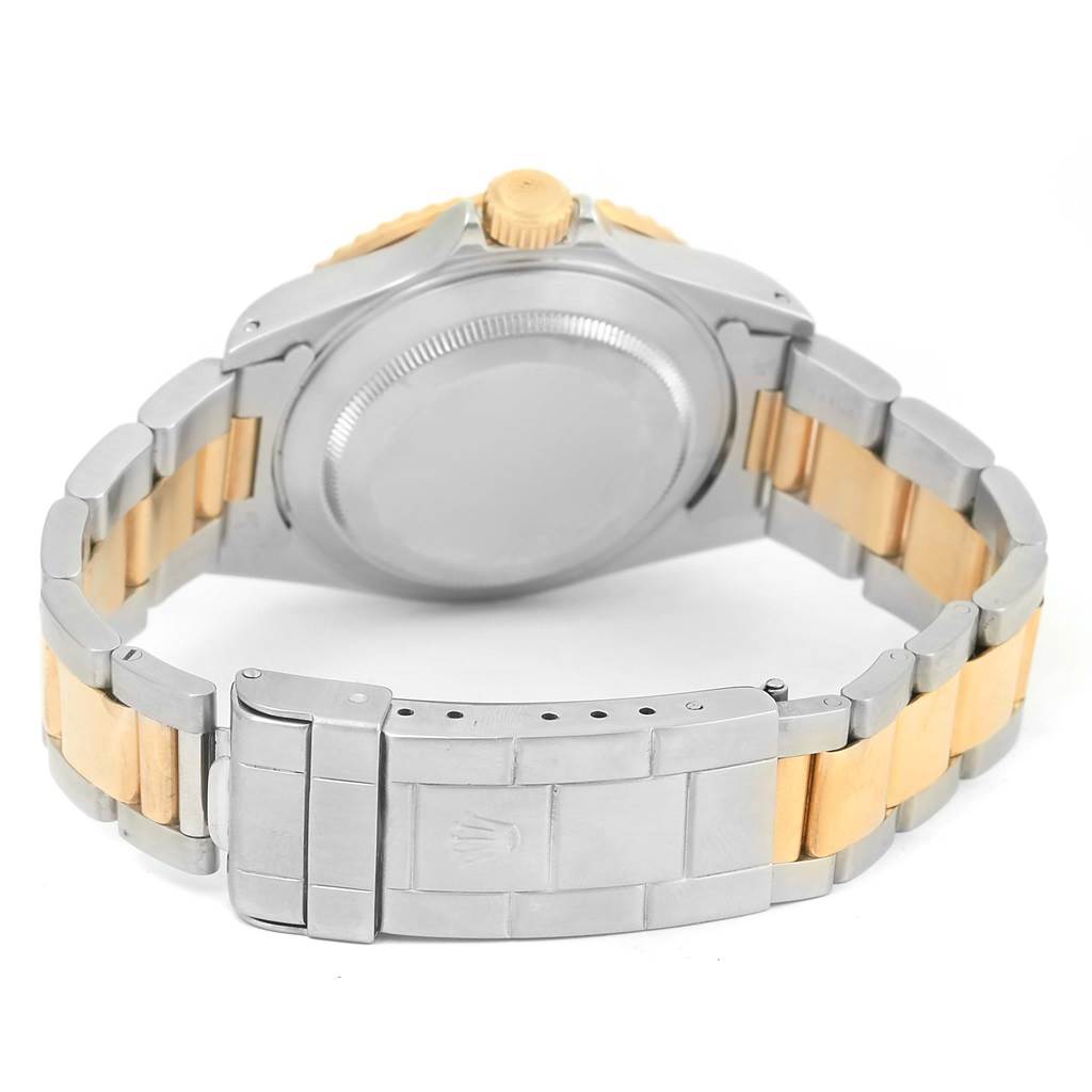 This image shows the back of a Rolex Submariner 16613 Men
s Steel and Gold (two tone) Grey Dial 16613 Men
s Steel and Gold (two tone) Grey Dial watch, highlighting its case back, bracelet, and clasp.