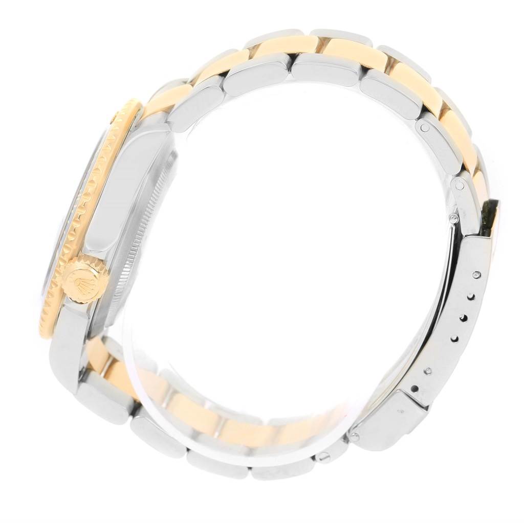 This image shows a side view of the Rolex Submariner 16613 Men
s Steel and Gold (two tone) Grey Dial 16613 Men
s Steel and Gold (two tone) Grey Dial watch, highlighting the bracelet and the crown.