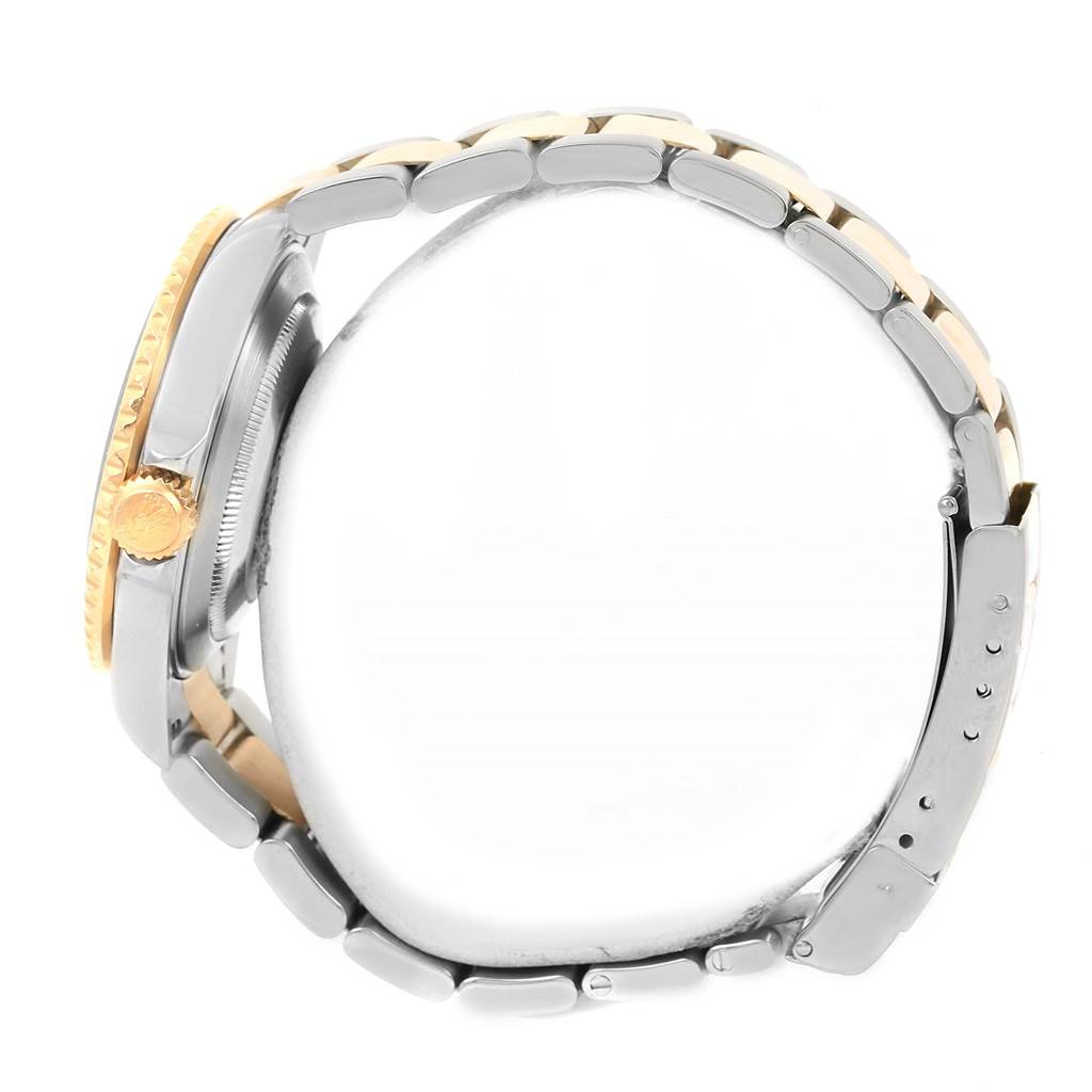 Side view of a Rolex Submariner 16613 Men
s Steel and Gold (two tone) Black Dial 16613 Men
s Steel and Gold (two tone) Black Dial watch, showing the bracelet, clasp, and crown.