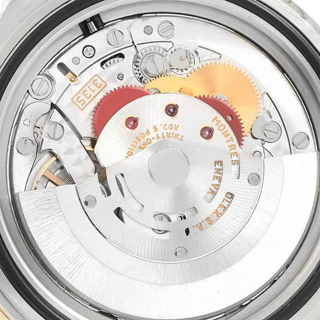 This image shows an inside view of the Rolex Submariner 16613 Men
s Steel and Gold (two tone) Black Dial 16613 Men
s Steel and Gold (two tone) Black Dial
s movement mechanism, including gears and intricate parts.