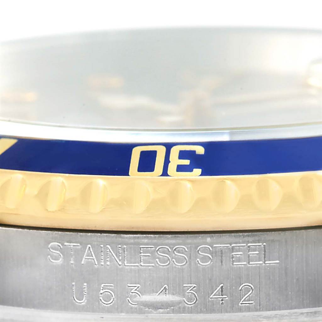 This image showcases the bezel and case serial number of a Rolex Submariner 16613 Men
s Steel and Gold (two tone) Grey Dial 16613 Men
s Steel and Gold (two tone) Grey Dial watch.