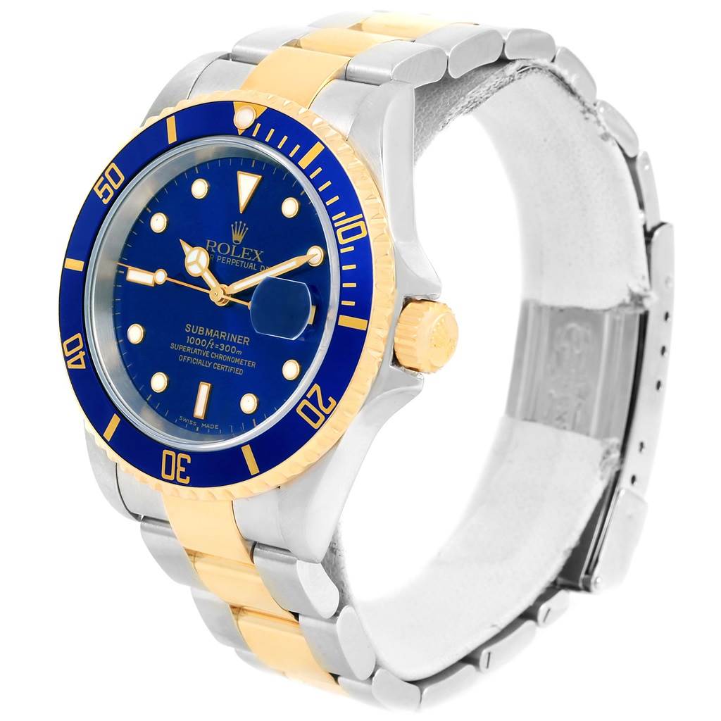 The image shows a Rolex Submariner 16613 Men
s Steel and Gold (two tone) Blue Dial 16613 Men
s Steel and Gold (two tone) Blue Dial watch at a 3/4 angle, displaying the face, bezel, and part of the steel and gold bracelet.