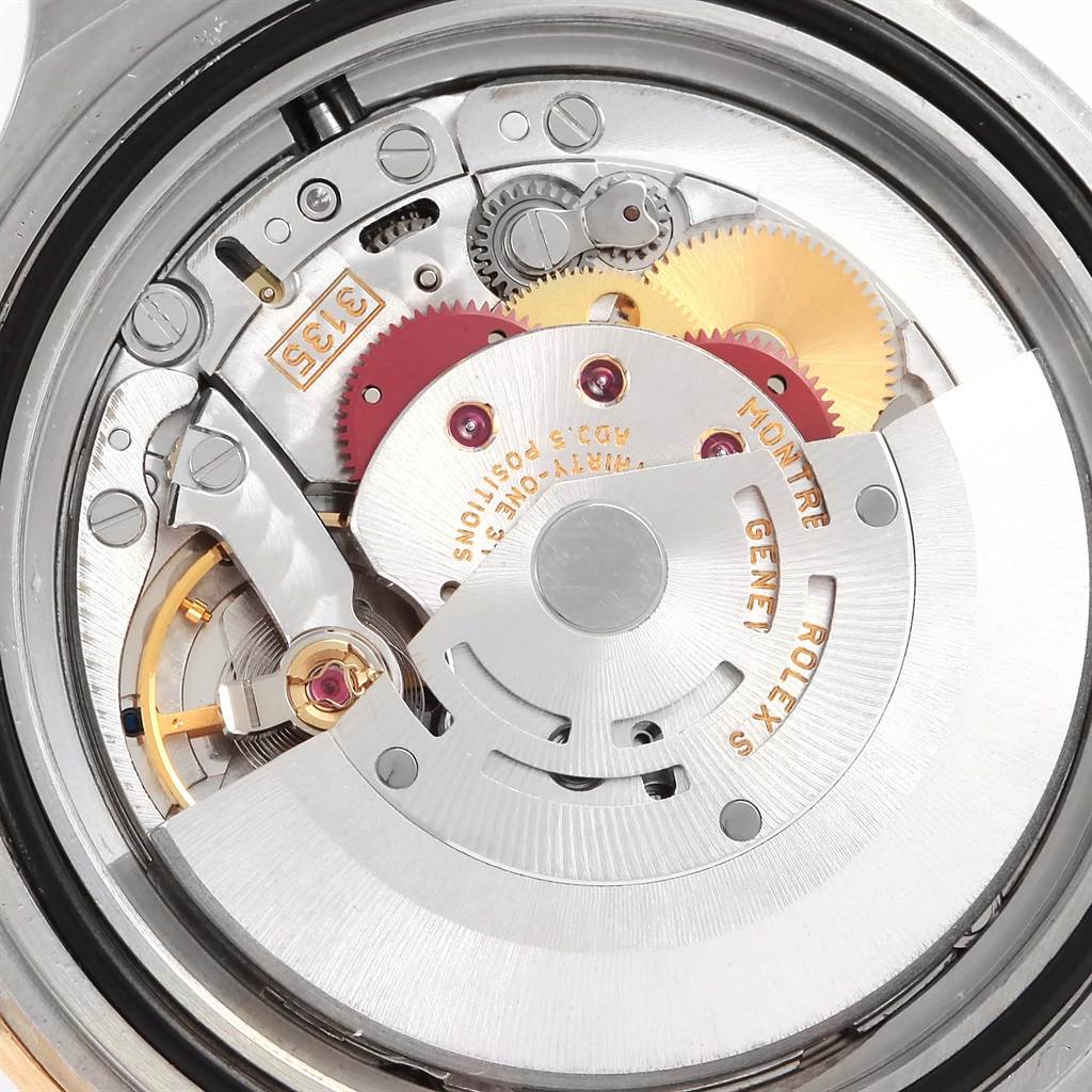 This image shows a detailed view of the movement mechanism inside a Rolex Submariner 16613 Men
s Steel and Gold (two tone) Blue Dial 16613 Men
s Steel and Gold (two tone) Blue Dial watch.