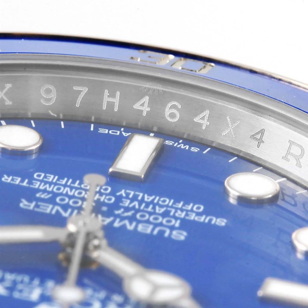 This close-up angle of the Rolex Submariner 116619LB Men's White Gold Blue Dial 116619LB Men's White Gold Blue Dial shows part of the dial, hands, and the rehaut with model-related engravings.