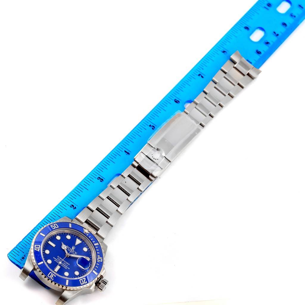 The Rolex Submariner 116619LB Men's White Gold Blue Dial 116619LB Men's White Gold Blue Dial watch is shown from an overhead angle, highlighting the full band and face alongside a measuring ruler.
