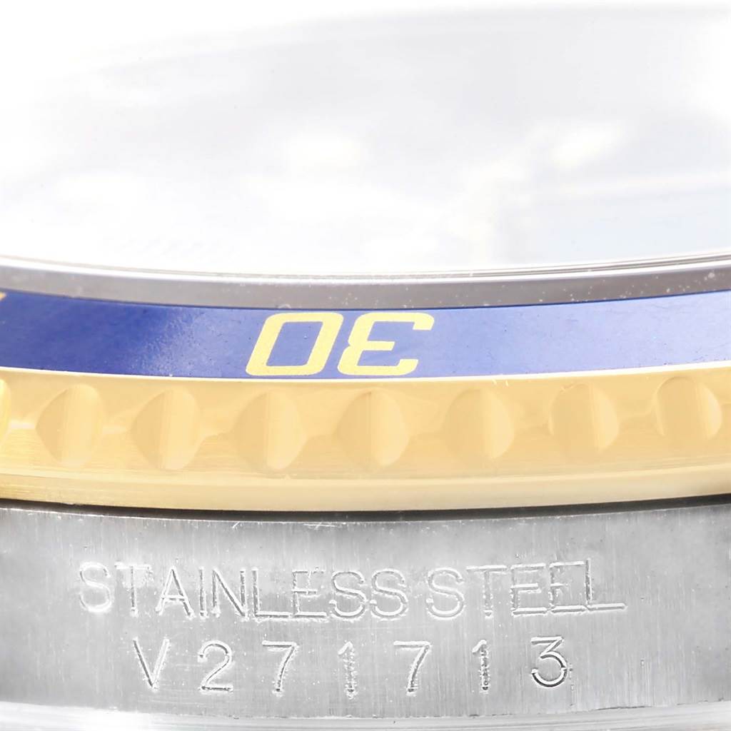 This image shows a close-up of the bezel and side of a Rolex Submariner 16613 Men
s Steel and Gold (two tone) Blue Dial 16613 Men
s Steel and Gold (two tone) Blue Dial watch, highlighting the "30" marking and part of the serial number.