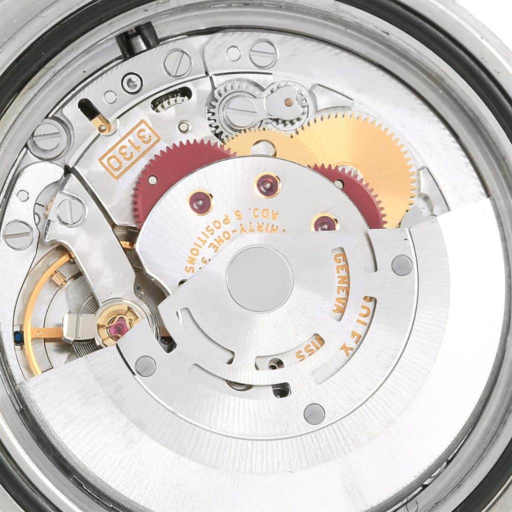 This image shows an internal view of the Rolex Submariner 14060 Men
s Stainless Steel Black Dial 14060 Men
s Stainless Steel Black Dial watch, highlighting its intricate mechanical movement components.