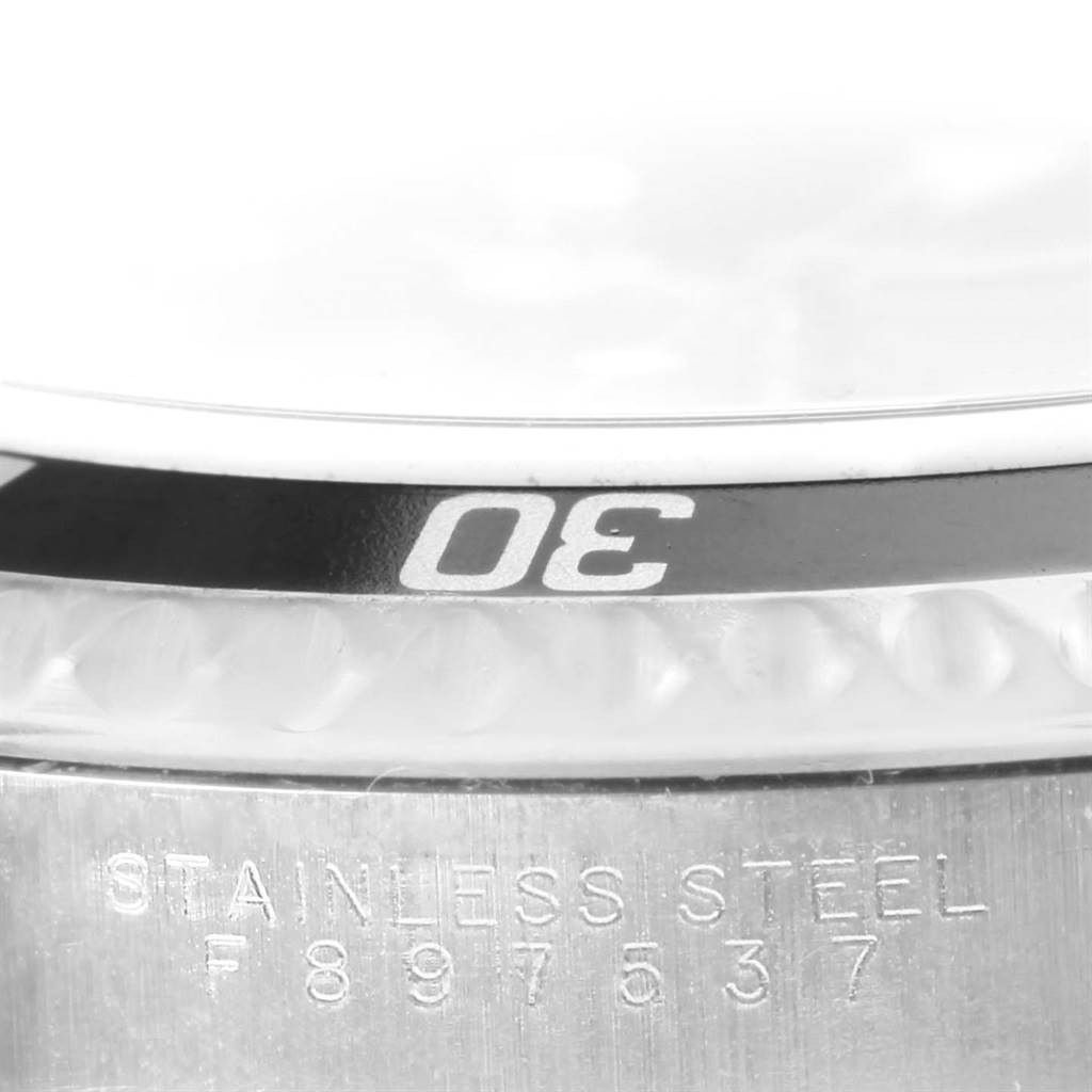 The image shows a close-up of the bezel and stainless steel case back of a Rolex Submariner 14060 Men
s Stainless Steel Black Dial 14060 Men
s Stainless Steel Black Dial watch.