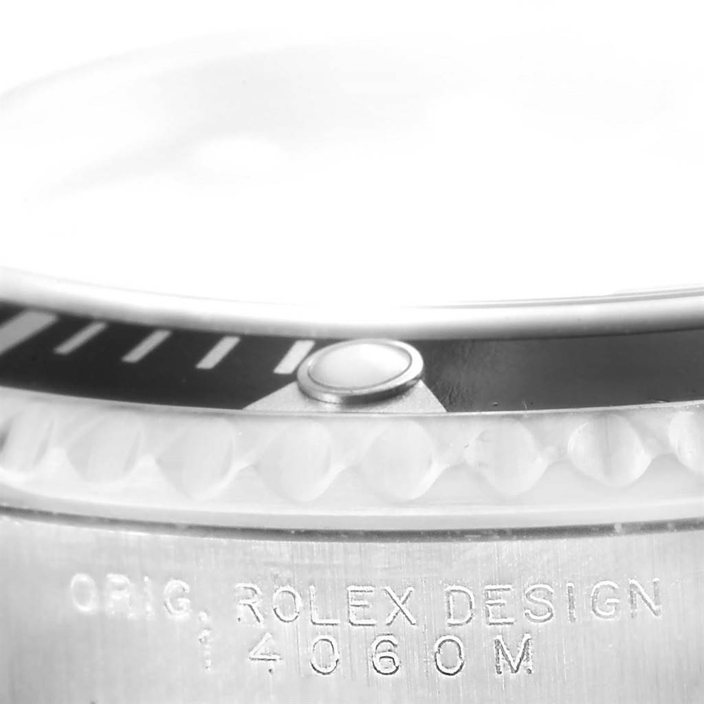 The image shows a close-up of the bezel and case side of a Rolex Submariner 14060 Men
s Stainless Steel Black Dial 14060 Men
s Stainless Steel Black Dial model, highlighting the "ORIG. ROLEX DESIGN" engraving and model number.