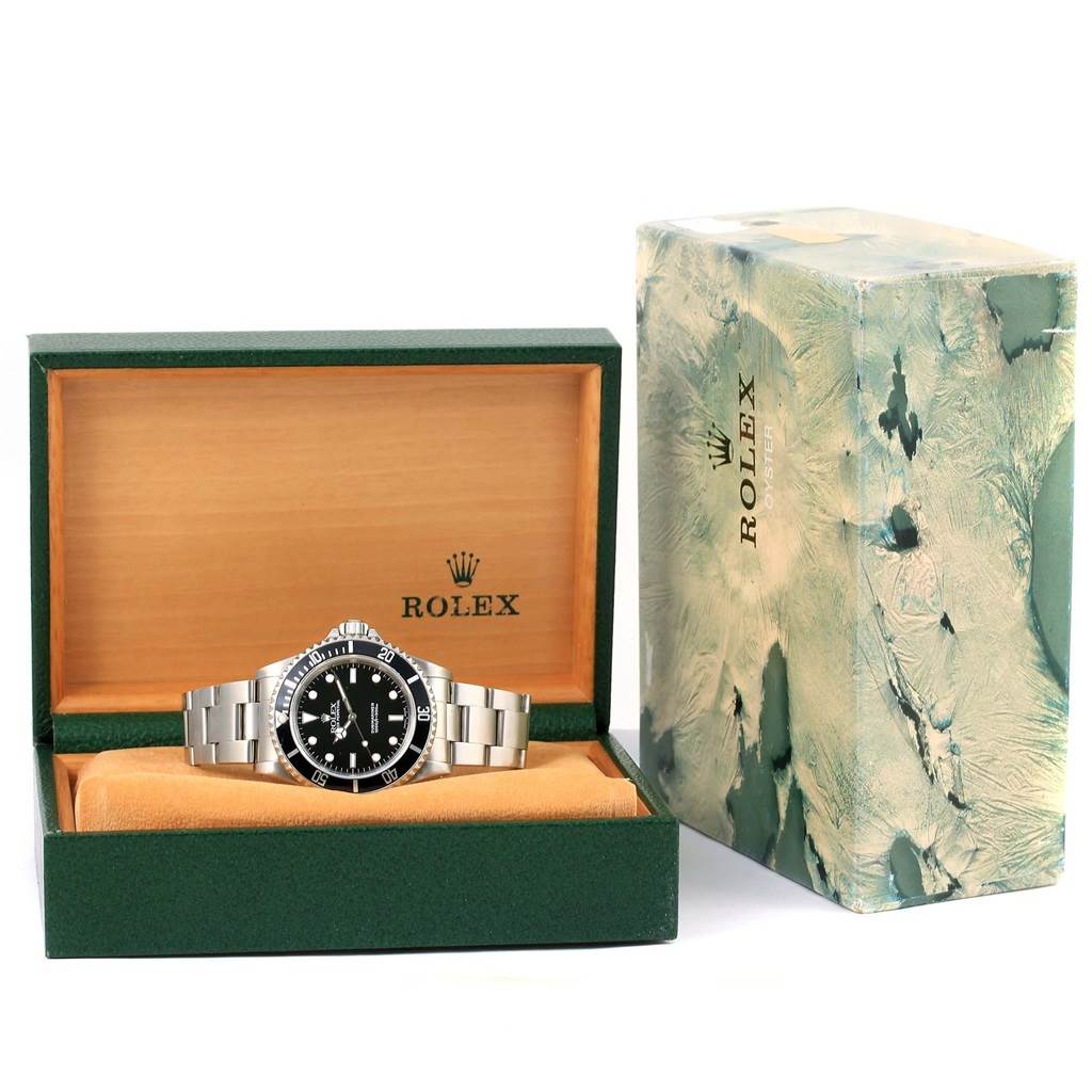 The Rolex Submariner 14060 Men
s Stainless Steel Black Dial 14060 Men
s Stainless Steel Black Dial watch is displayed in its open box, with the box lid beside it.