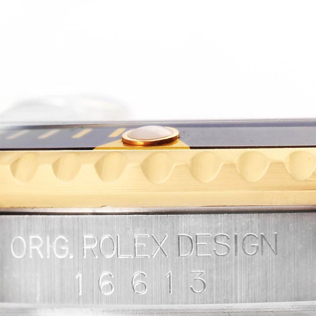 This close-up angle shows the side of the bezel and case of a Rolex Submariner 16613 Men
s Steel and Gold (two tone) Black Dial 16613 Men
s Steel and Gold (two tone) Black Dial, highlighting the "ORIG. ROLEX DESIGN 16613" engraving.