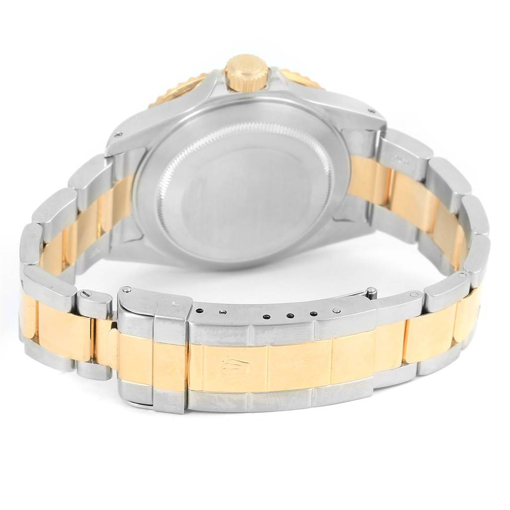 This image shows the back case and bracelet of a Rolex Submariner 16613 Men
s Steel and Gold (two tone) Black Dial 16613 Men
s Steel and Gold (two tone) Black Dial watch, featuring a two-tone metal design.