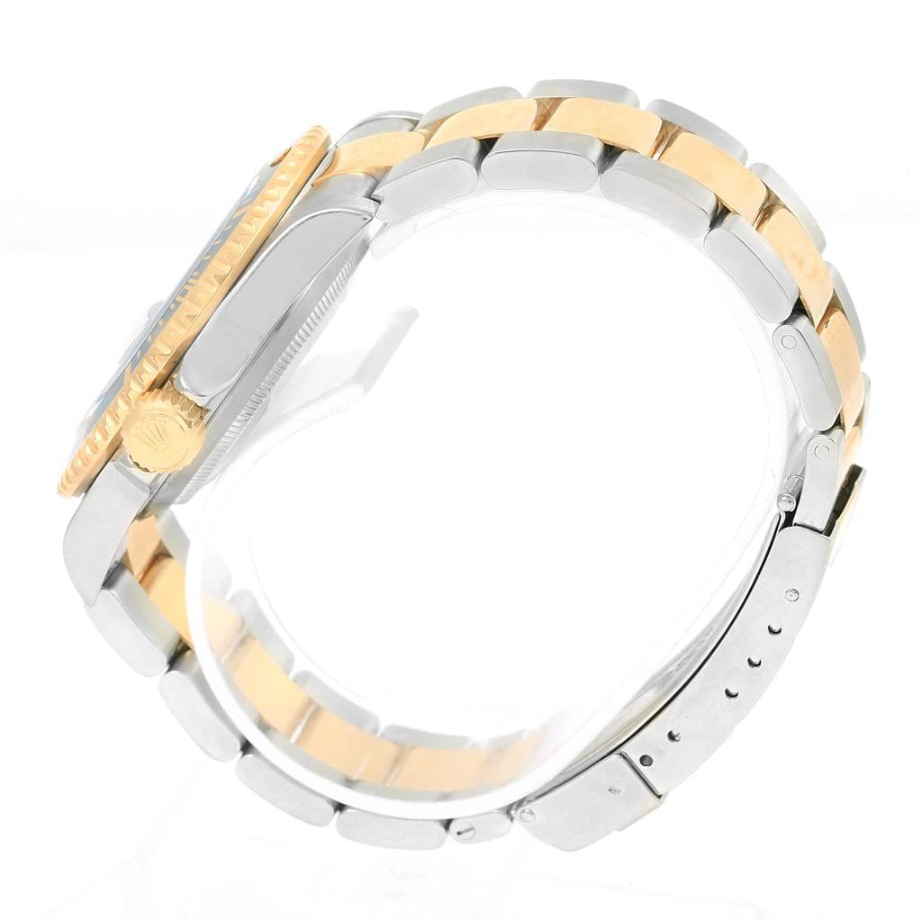 The image shows a side view of a Rolex Submariner 16613 Men
s Steel and Gold (two tone) Blue Dial 16613 Men
s Steel and Gold (two tone) Blue Dial watch focusing on the crown, case, and two-tone bracelet.