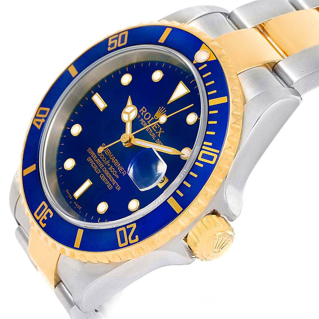 The image shows a side and front angle of a Rolex Submariner 16613 Men
s Steel and Gold (two tone) Blue Dial 16613 Men
s Steel and Gold (two tone) Blue Dial watch, showcasing its blue dial, bezel, and metal bracelet.