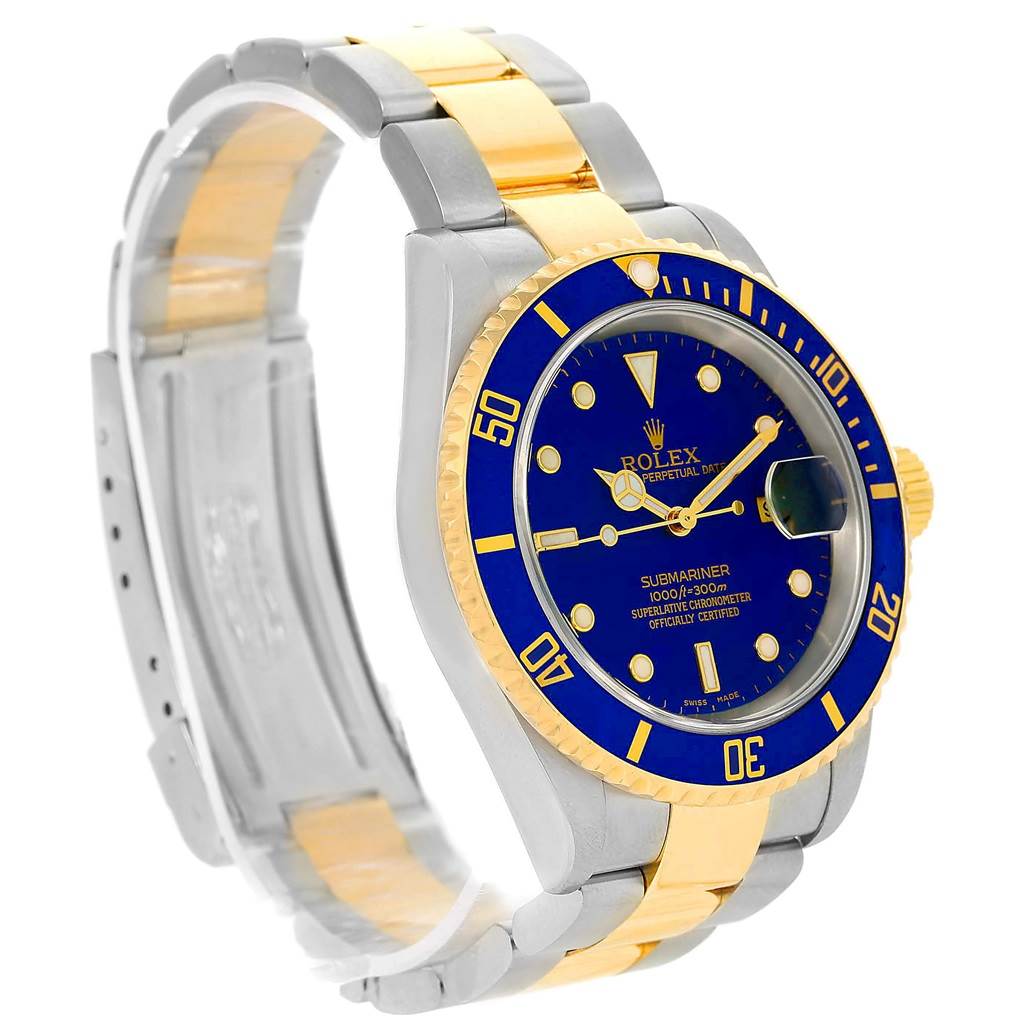 The image shows a Rolex Submariner 16613 Men
s Steel and Gold (two tone) Blue Dial 16613 Men
s Steel and Gold (two tone) Blue Dial watch at a three-quarter angle, highlighting the blue dial, bezel, and two-tone bracelet.