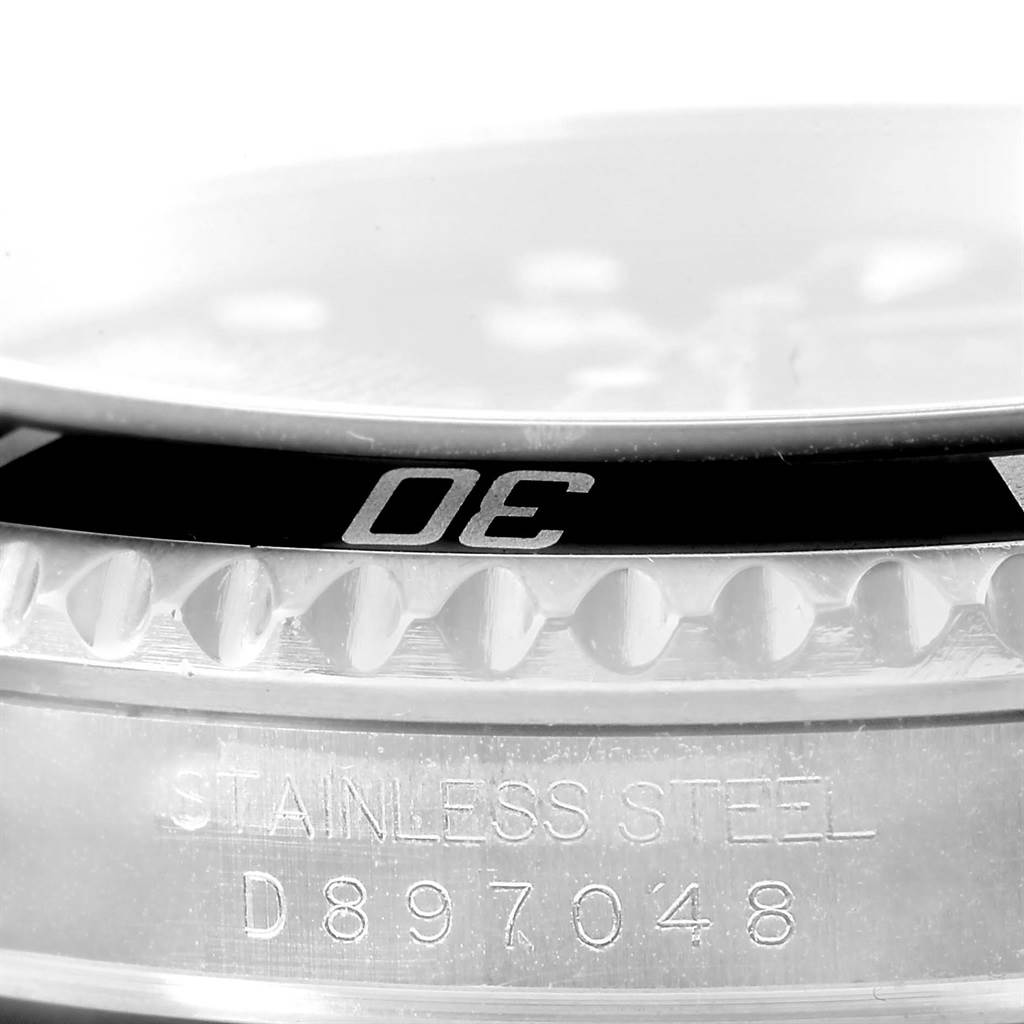 The image shows a close-up angle of the bezel and case side of the Rolex Submariner 16610 Men
s Stainless Steel Black Dial 16610 Men
s Stainless Steel Black Dial watch, highlighting the serial number and portions of the bezel
s markings.