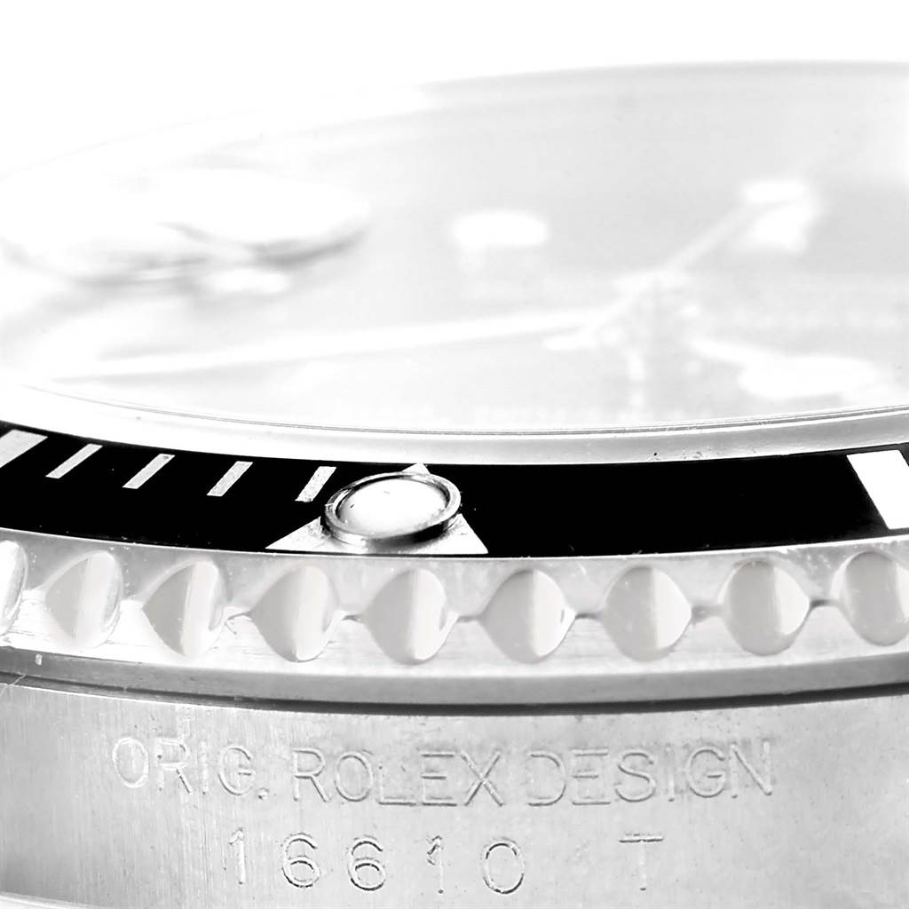 The close-up image shows the bezel, crystal, and part of the case with the engravings on a Rolex Submariner 16610 Men
s Stainless Steel Black Dial 16610 Men
s Stainless Steel Black Dial model.