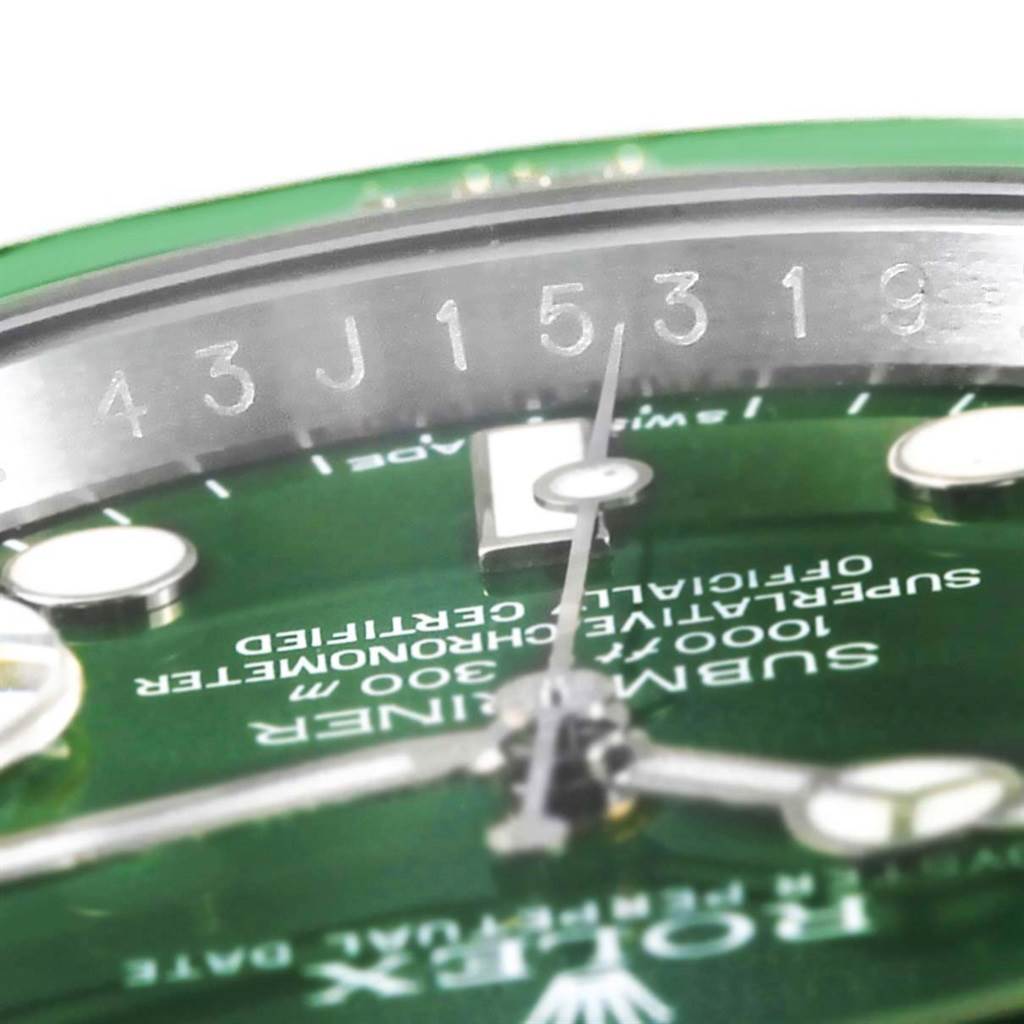 This image shows a close-up of the Rolex Submariner 116610LV Men
s Stainless Steel Green Dial 116610LV Men
s Stainless Steel Green Dial watch, focusing on its green dial and the serial number on the inner bezel.