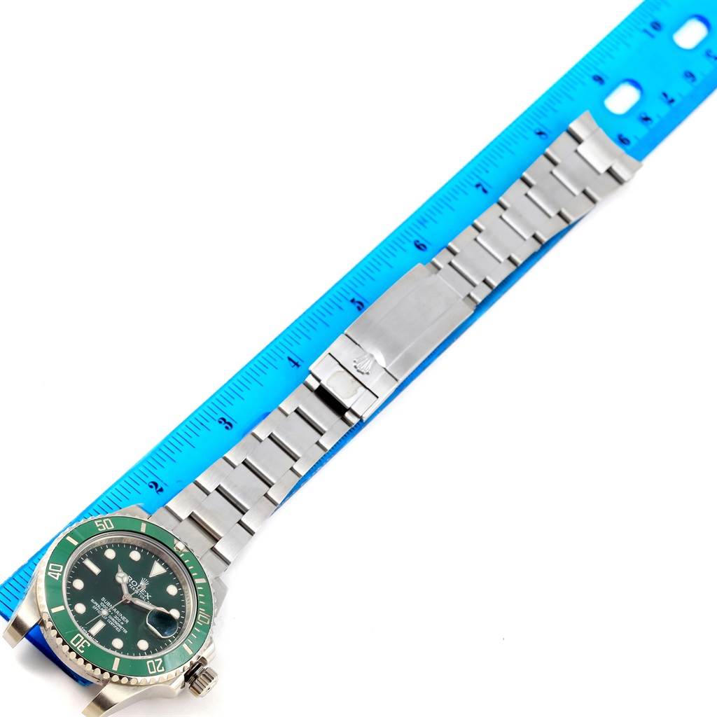 The Rolex Submariner 116610LV Men
s Stainless Steel Green Dial 116610LV Men
s Stainless Steel Green Dial watch is shown from a top-down angle, including the face, bezel, bracelet, clasp, and a measuring ruler.