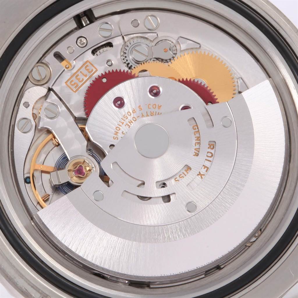 This is a close-up view of the movement mechanism of a Rolex Submariner 116610LV Men
s Stainless Steel Green Dial 116610LV Men
s Stainless Steel Green Dial watch, showing gears and rotors.