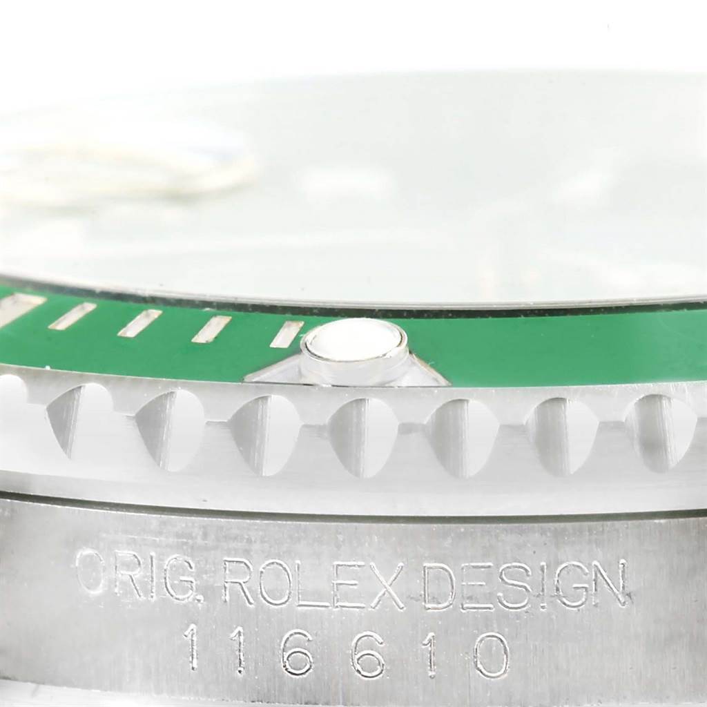 This close-up image of the Rolex Submariner 116610LV Men
s Stainless Steel Green Dial 116610LV Men
s Stainless Steel Green Dial watch shows the bezel, part of the dial, and the case with the model number 116610.