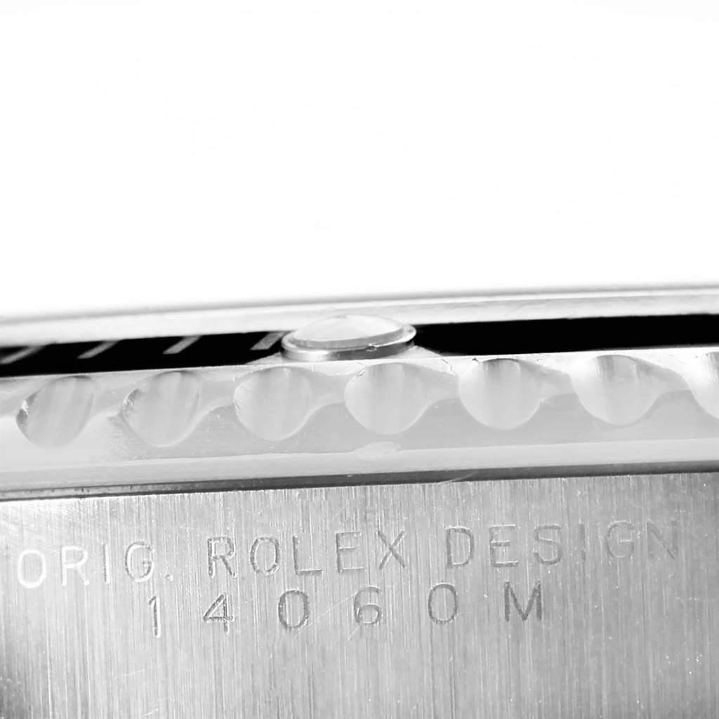 The image shows a close-up of the Rolex Submariner 14060 Men
s Stainless Steel Black Dial 14060 Men
s Stainless Steel Black Dial model
s side, featuring the bezel edge and model number engraving.