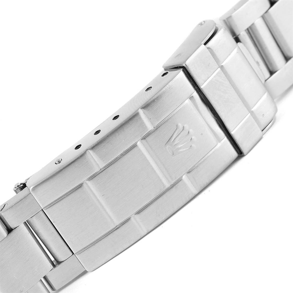 This image shows the clasp of a Rolex Submariner 14060 Men
s Stainless Steel Black Dial 14060 Men
s Stainless Steel Black Dial watch bracelet from a side angle.