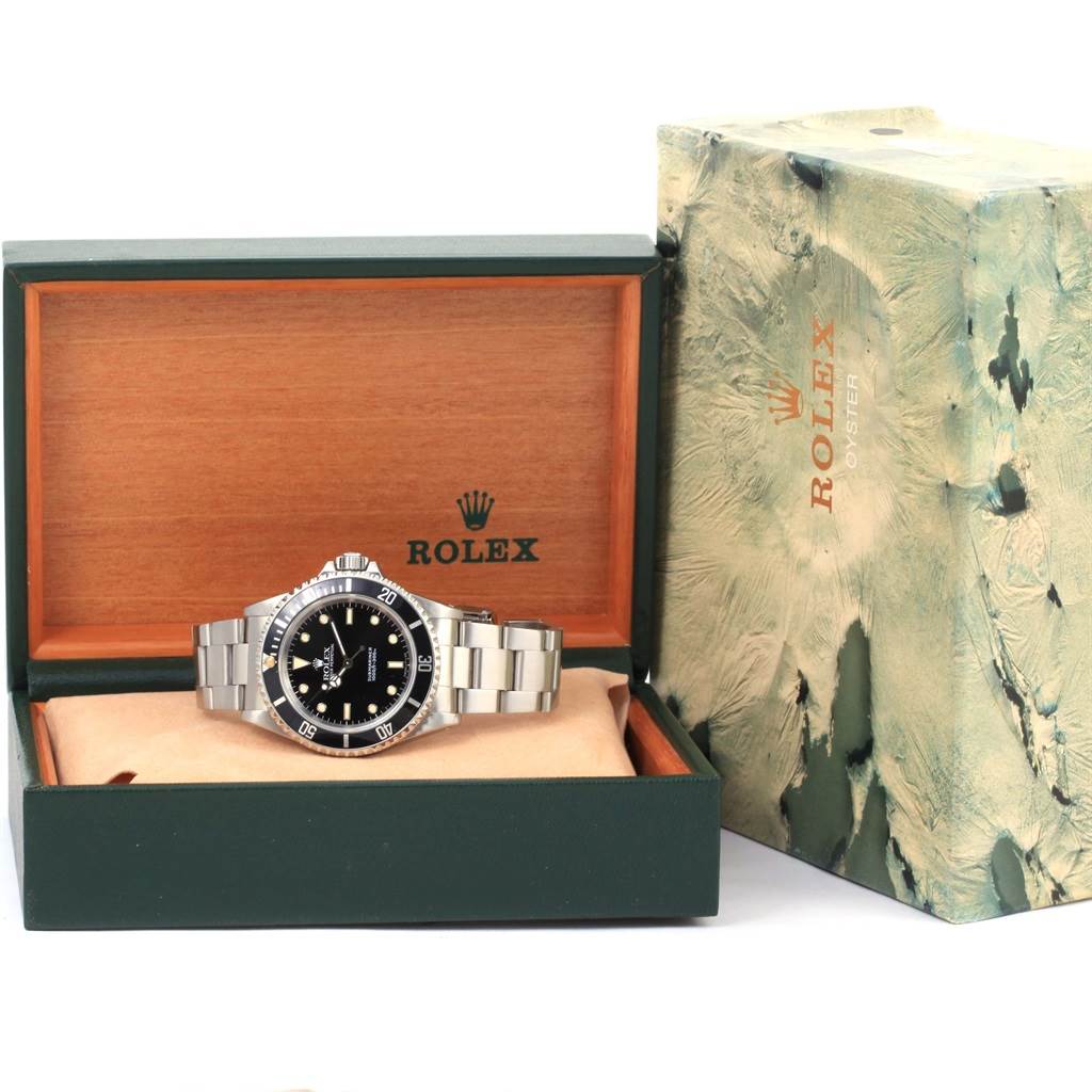 The image shows a Rolex Submariner 14060 Men
s Stainless Steel Black Dial 14060 Men
s Stainless Steel Black Dial watch in its open presentation box alongside an outer box.
