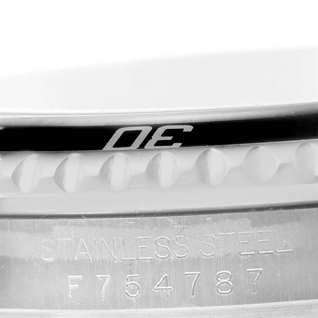 This close-up image displays the side bezel and part of the casing with serial markings of the Rolex Submariner 16610 Men
s Stainless Steel Black Dial 16610 Men
s Stainless Steel Black Dial watch.