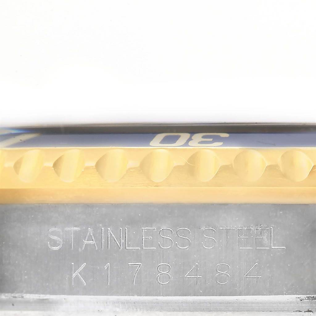 The image shows a close-up of the side bezel and serial number engraving on a Rolex Submariner 16613 Men
s Steel and Gold (two tone) Blue Dial 16613 Men
s Steel and Gold (two tone) Blue Dial watch.