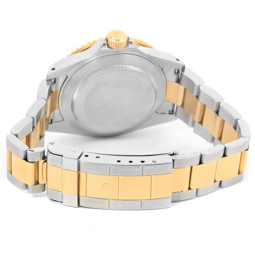 This image shows the back case and clasp of a Rolex Submariner 16613 Men
s Steel and Gold (two tone) Blue Dial 16613 Men
s Steel and Gold (two tone) Blue Dial watch in silver and gold.