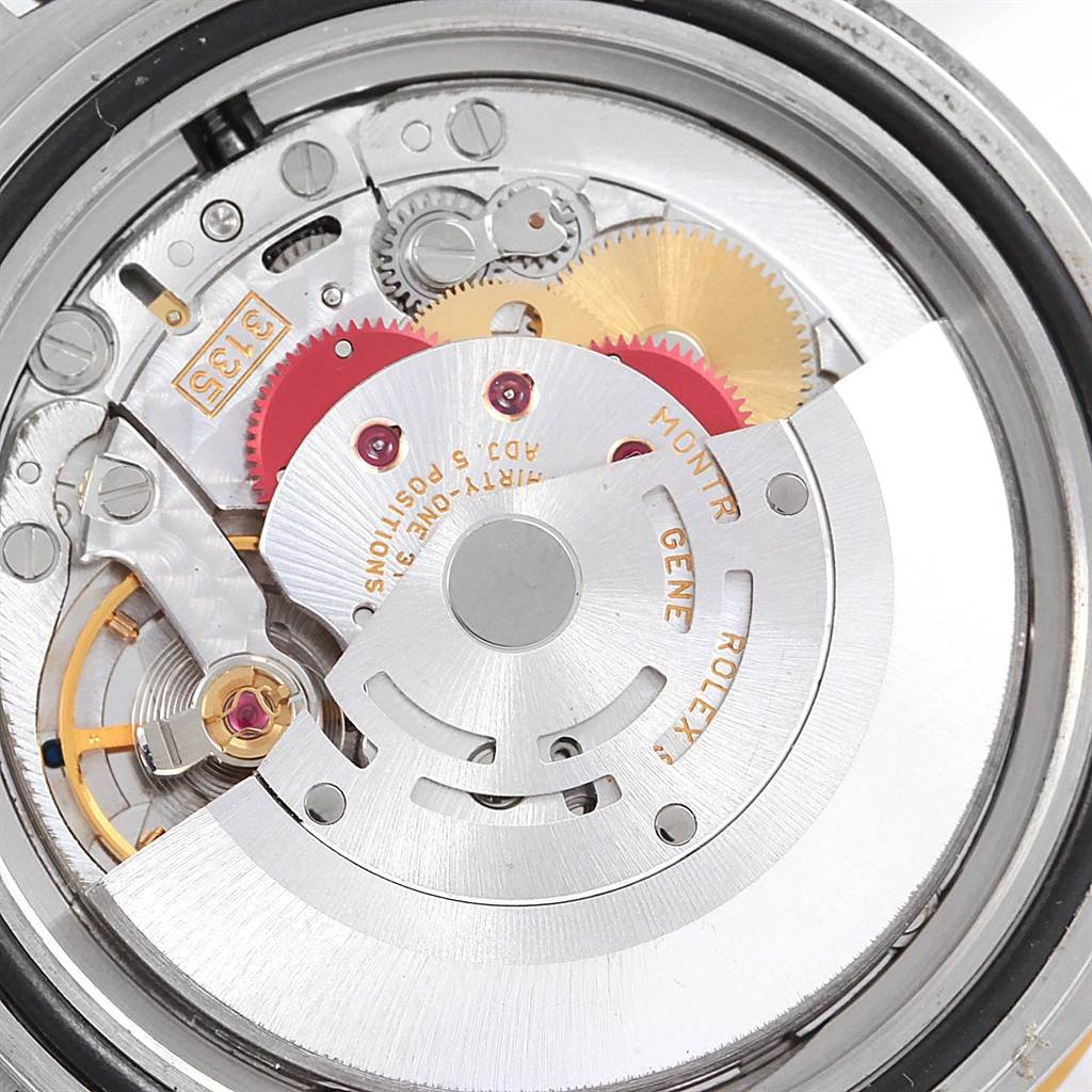 The image shows the rear view of a Rolex Submariner 16613 Men
s Steel and Gold (two tone) Blue Dial 16613 Men
s Steel and Gold (two tone) Blue Dial watch, focusing on its internal mechanical movement components.