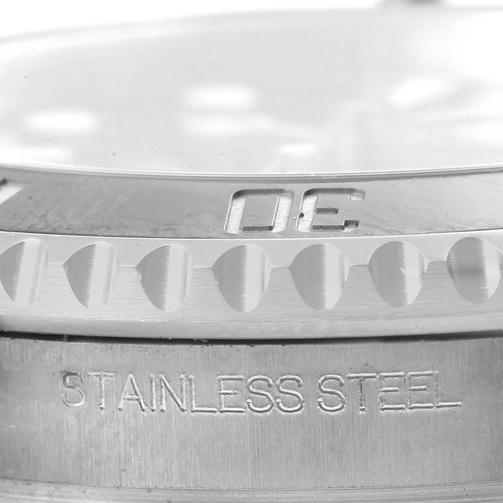 The image shows a close-up side view of the bezel and the "STAINLESS STEEL" engraving on the Rolex Submariner 114060 Men
s Stainless Steel Black Dial 114060 Men
s Stainless Steel Black Dial watch.
