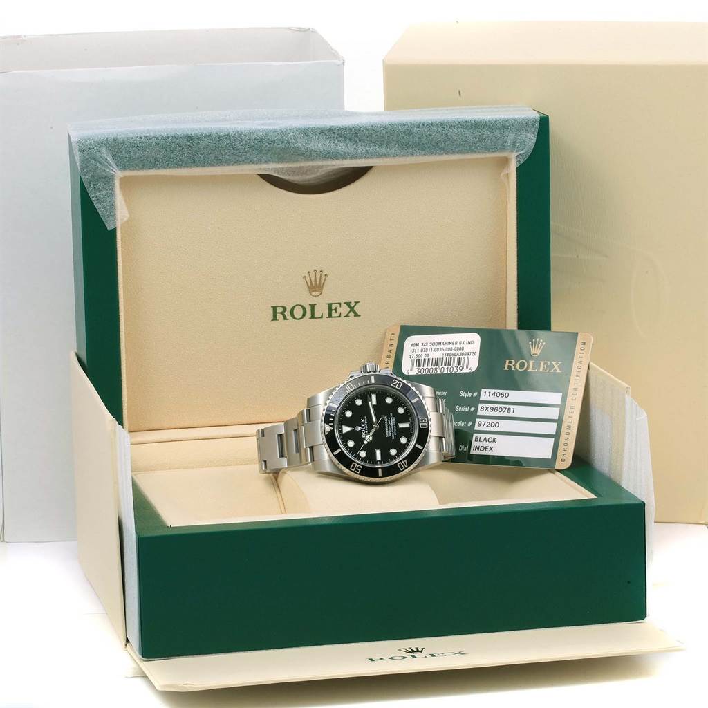 The Rolex Submariner 114060 Men
s Stainless Steel Black Dial 114060 Men
s Stainless Steel Black Dial watch is displayed at an angle in its open box along with its certification cards.