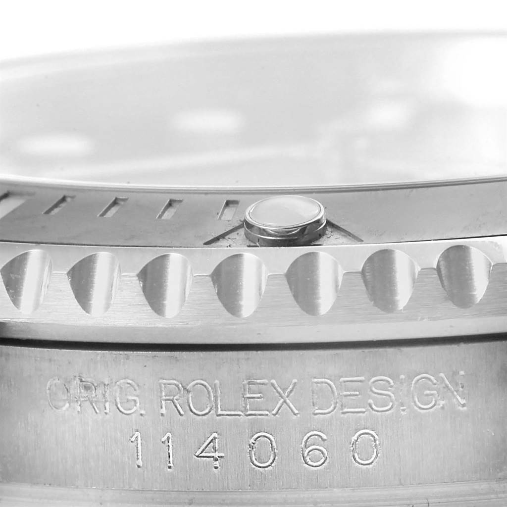 This close-up image shows part of the bezel and case side of a Rolex Submariner 114060 Men
s Stainless Steel Black Dial 114060 Men
s Stainless Steel Black Dial, highlighting the model number "114060".
