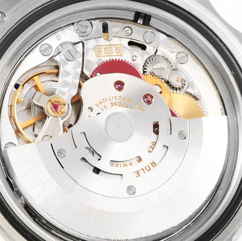 The image shows an internal view of the Rolex Submariner 16610 Men's Stainless Steel Black Dial 16610 Men's Stainless Steel Black Dial watch movement, highlighting the rotor, gears, and other mechanical parts.