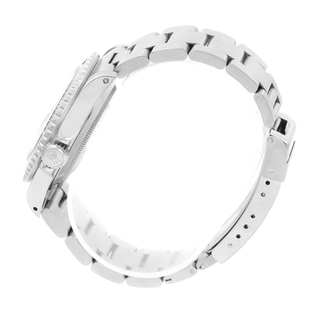 The image shows a side view of a Rolex Submariner 16610 Men
s Stainless Steel Black Dial 16610 Men
s Stainless Steel Black Dial, focusing on the bracelet, case, crown, and clasp.