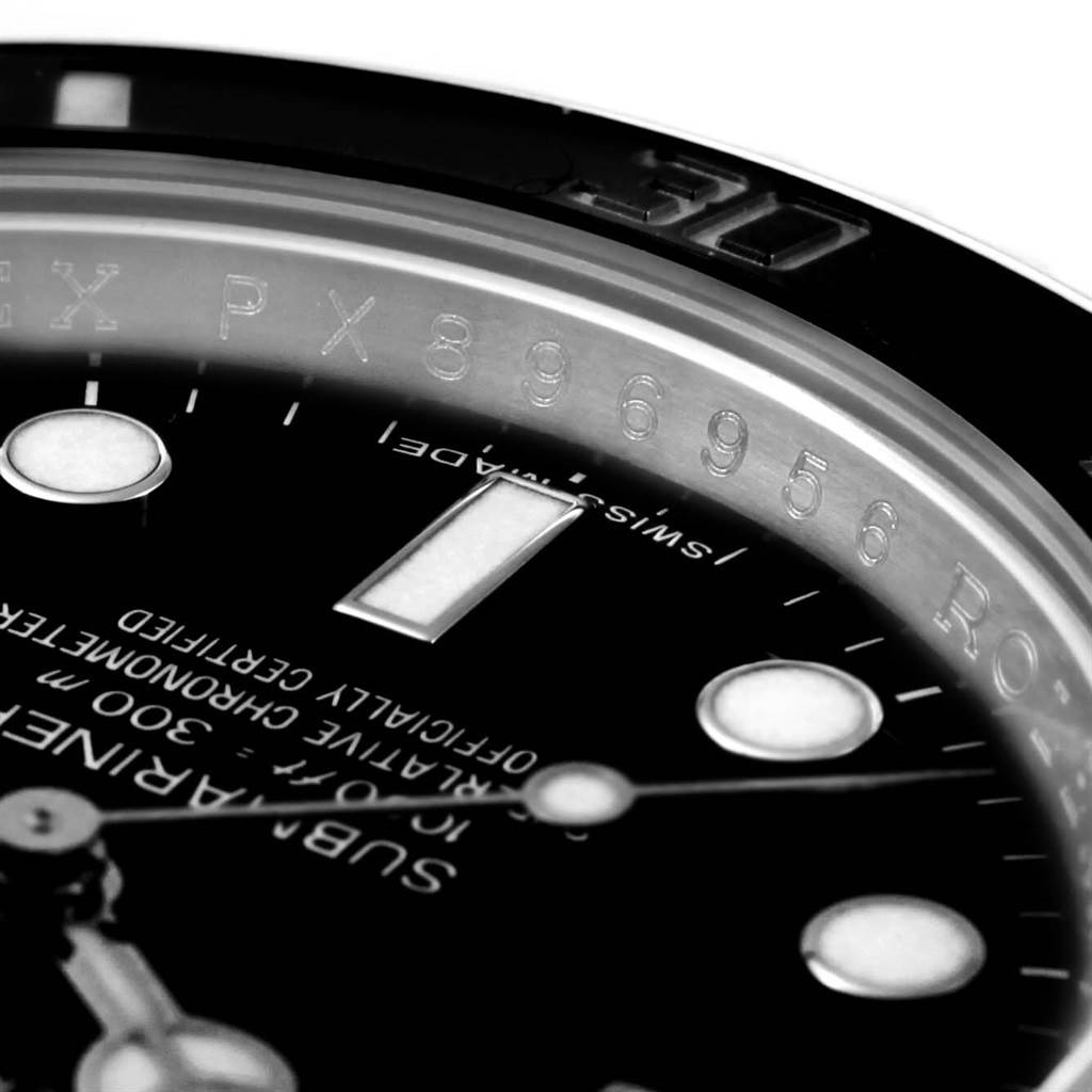 This close-up angle of the Rolex Submariner 114060 Men
s Stainless Steel Black Dial 114060 Men
s Stainless Steel Black Dial watch shows the dial, markers, minute hand, and part of the bezel.