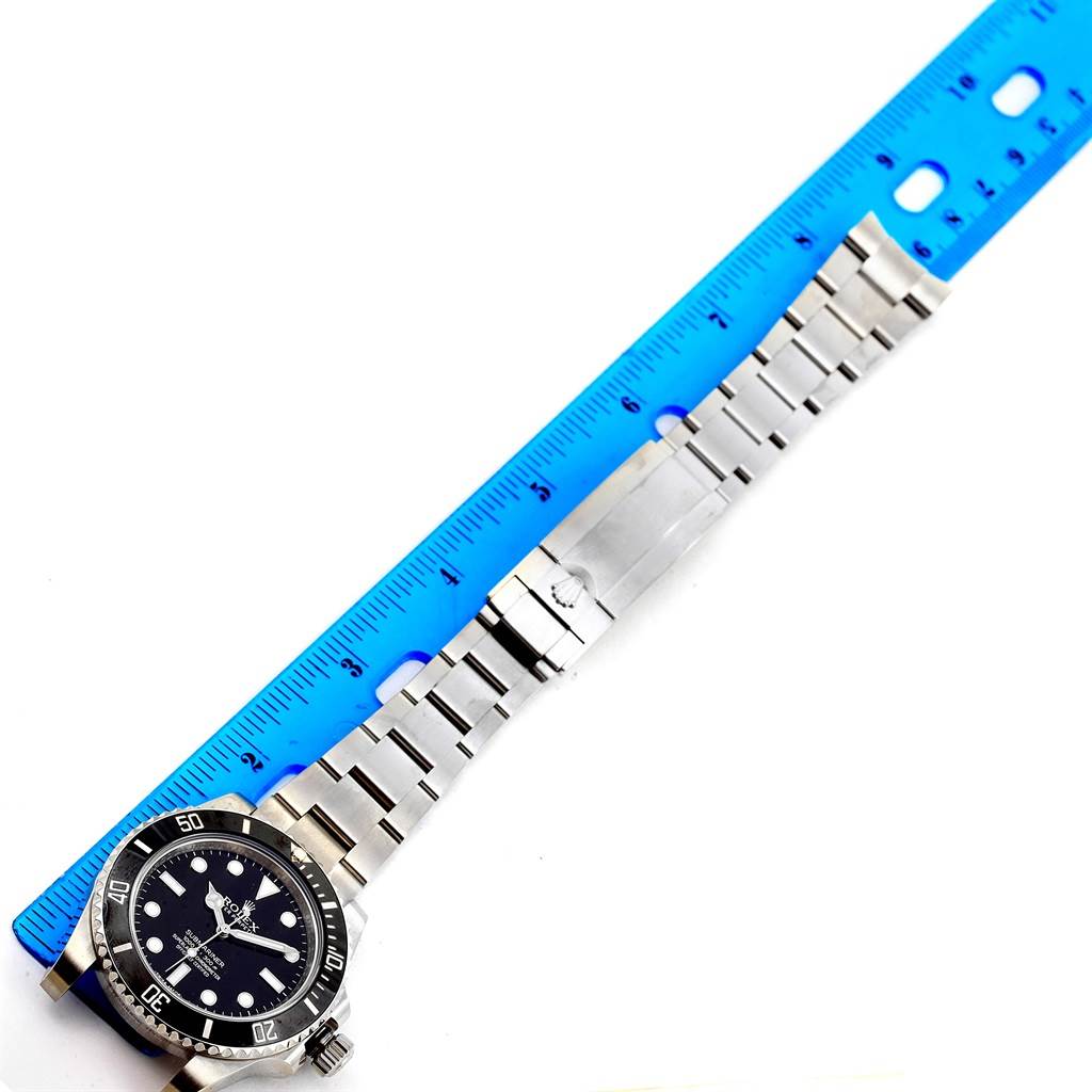 The image shows a top-down view of a Rolex Submariner 114060 Men
s Stainless Steel Black Dial 114060 Men
s Stainless Steel Black Dial watch with a stainless steel bracelet, aligned with a ruler for measurement.