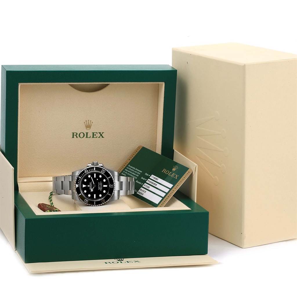 The Rolex Submariner 114060 Men
s Stainless Steel Black Dial 114060 Men
s Stainless Steel Black Dial watch is displayed inside its green and beige box with accompanying paperwork and a hand tag visible.