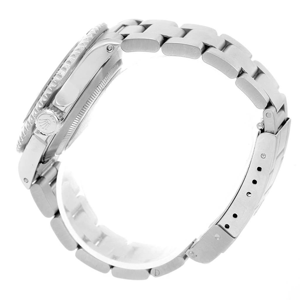 The image shows a side view of a Rolex Submariner 16610 Men
s Stainless Steel Black Dial 16610 Men
s Stainless Steel Black Dial, highlighting the watch
s case, crown, and bracelet with the clasp partially visible.