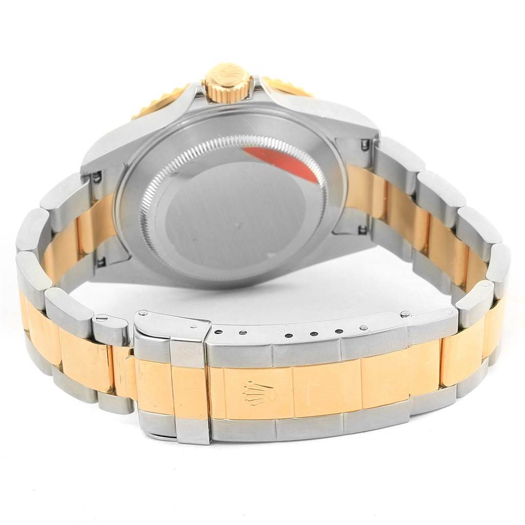 This image shows the back case, crown, and bracelet of a Rolex Submariner 16613 Men's Steel and Gold (two tone) Blue Dial 16613 Men's Steel and Gold (two tone) Blue Dial watch.