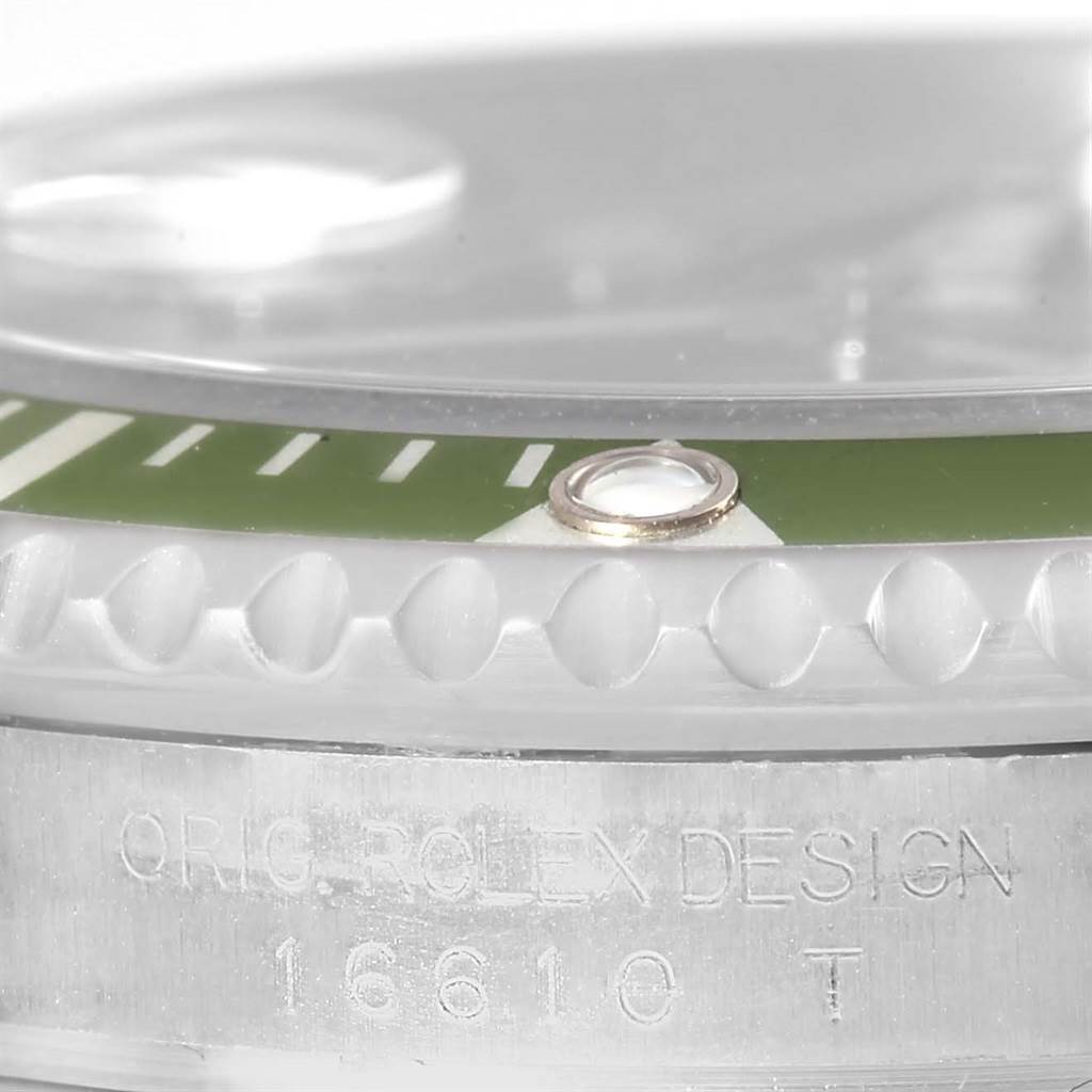 This close-up image shows the bezel, crystal, and part of the casing with the serial number of a Rolex Submariner 16610LV Men
s Stainless Steel Black Dial 16610LV Men
s Stainless Steel Black Dial watch.