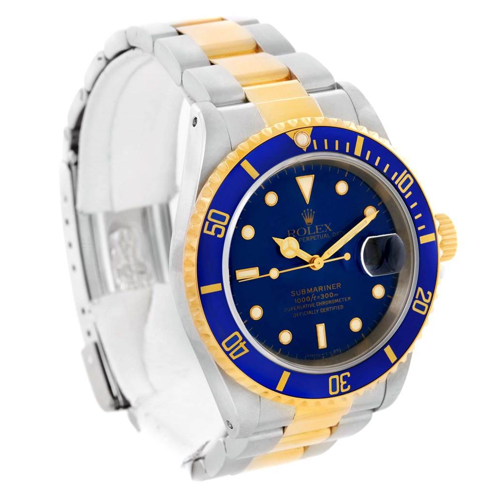 The image shows a Rolex Submariner 16613 Men's Steel and Gold (two tone) Blue Dial 16613 Men's Steel and Gold (two tone) Blue Dial watch from a front-angle, highlighting its blue dial, bezel, and two-tone bracelet.