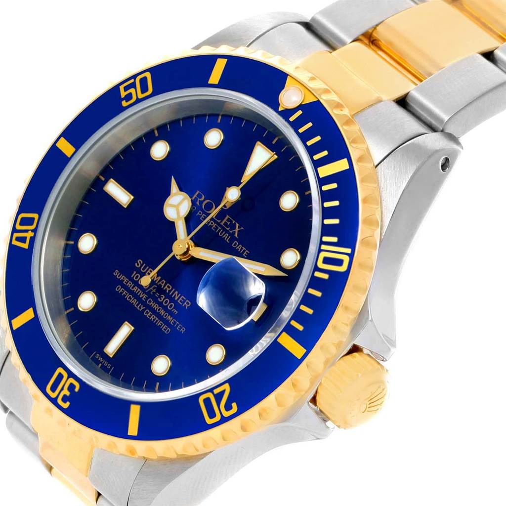 This image shows an angled view of the Rolex Submariner 16613 Men's Steel and Gold (two tone) Blue Dial 16613 Men's Steel and Gold (two tone) Blue Dial watch highlighting its blue dial and bezel, and two-tone bracelet.