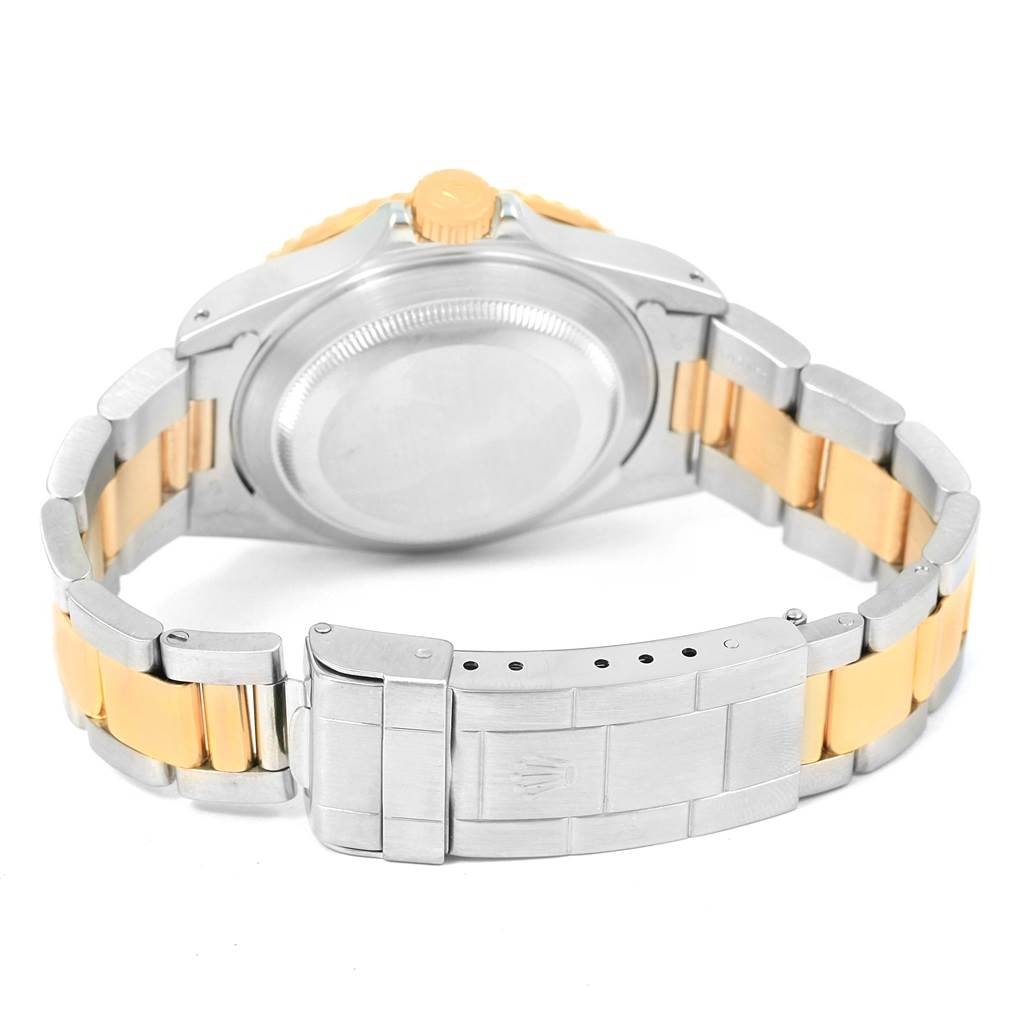 This image shows the back case, crown, bracelet, and clasp of a Rolex Submariner 16613 Men's Steel and Gold (two tone) Blue Dial 16613 Men's Steel and Gold (two tone) Blue Dial watch.